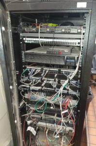 Industrial OT network cabinet with servers, fibre and Ethernet patch panels, switches and communication cabling