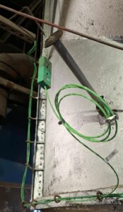Green Type K thermocouple extension cable with labelled TT1351 connection and service loop at an industrial incineration facility.