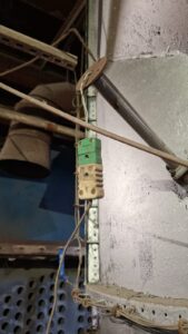 Existing thermocouple connection with aged wiring and connectors before cable replacement at an industrial incineration facility.